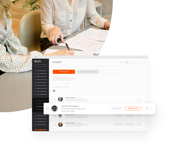 Personal Injury Lawyer Signing Documents with Her Client with a Snapshot of Thryv's CRM for Lawyers