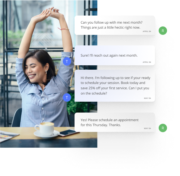 Physical Therapist Stretching Her Arms Up at a Table While Communicating with Customers Using Thryv's Software