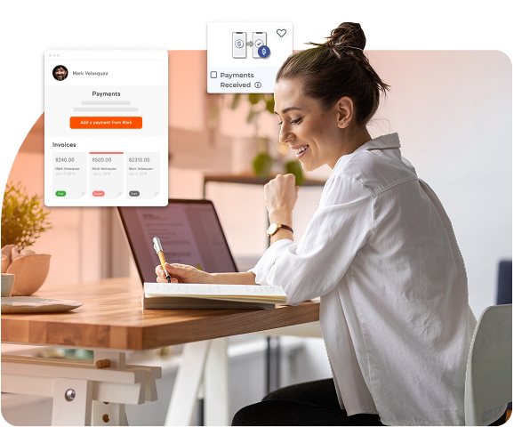A smiling woman sitting at a desk with a laptop and notebook, reviewing payment dashboard showing invoices and payment status.