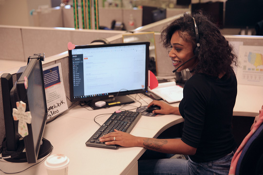 Employee enjoying a balanced work environment, representing Thryv’s comprehensive benefits that support health, financial security, and work-life balance.