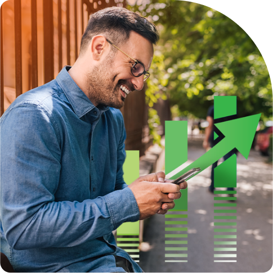 Smiling professional reviewing graphs and charts over his phone, representing successful SEO and increased website traffic.