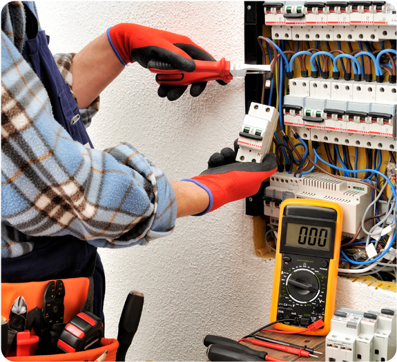 An electrician testing an outdoor panel against a white building