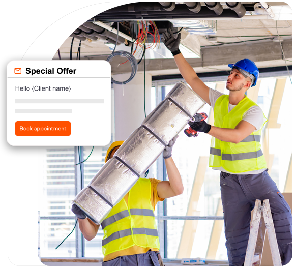 Two HVAC technicians installing ducts in the ceiling of a commercial building