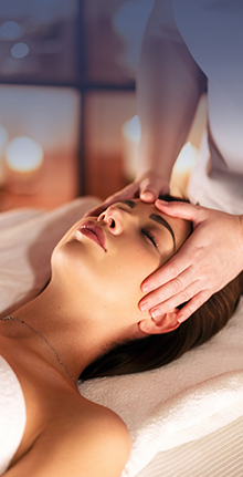 Person receiving a relaxation or therapeutic Med Spa treatment on a massage table.