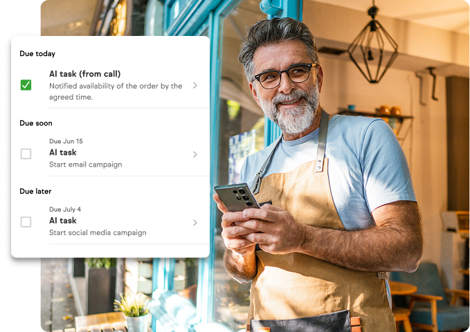 Man on his phone smiling with tasks notifications in front of him
