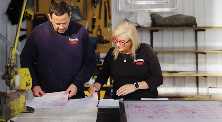 Statewide Skylights team members looking at the blueprint.