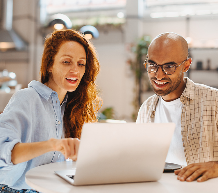 Two business owners reviewing their laptop together